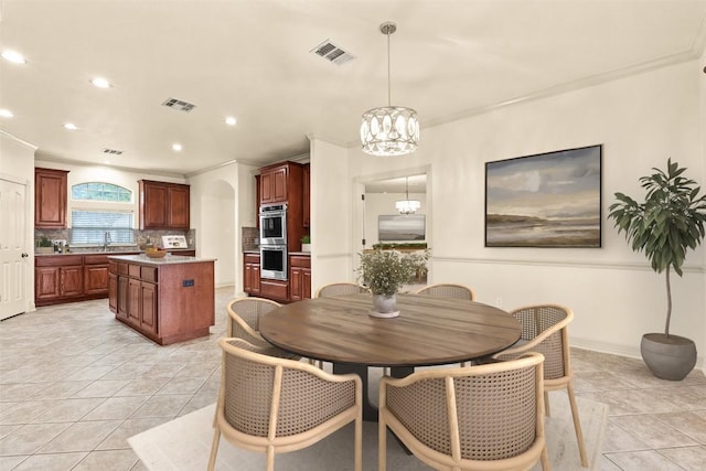 2908 Arbor Ct, Round Rock, TX 78681 - dining room featuring a chandelier, ornamental molding, recessed lighting, light tile patterned flooring, and arched walkways
