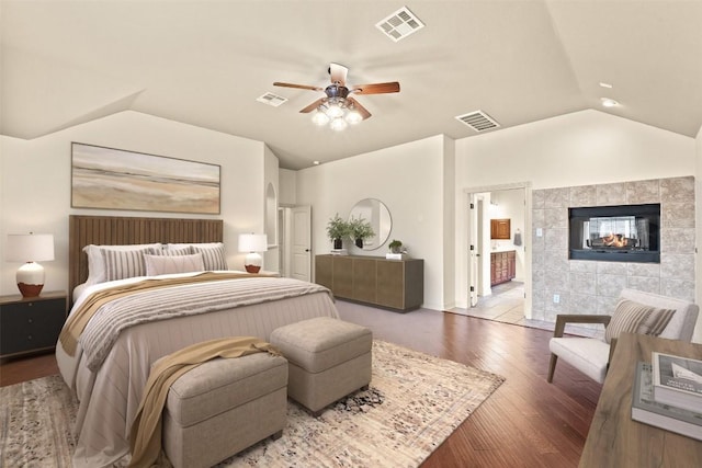 2908 Arbor Ct, Round Rock, TX 78681 - bedroom featuring vaulted ceiling, wood finished floors, ensuite bath, a fireplace, and a ceiling fan