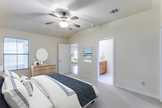 13604 Caldwell Dr Unit 72, Austin, TX 78750 - bedroom with light colored carpet, vaulted ceiling, connected bathroom, and a ceiling fan
