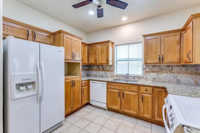 13604 Caldwell Dr Unit 72, Austin, TX 78750 - kitchen with white appliances, ceiling fan, tasteful backsplash, brown cabinetry, and light tile patterned flooring