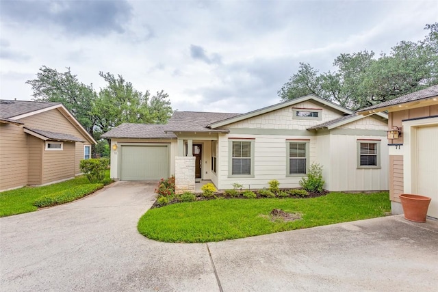 13604 Caldwell Dr Unit 72, Austin, TX 78750 - view of front facade featuring a garage, driveway, a front yard, and roof with shingles