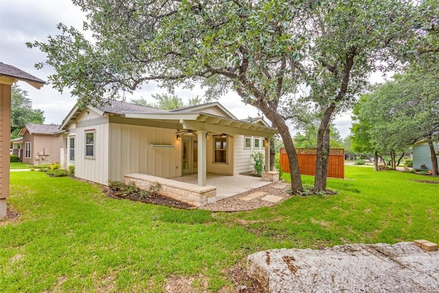 13604 Caldwell Dr Unit 72, Austin, TX 78750 - back of house featuring a lawn, a patio area, ceiling fan, and board and batten siding