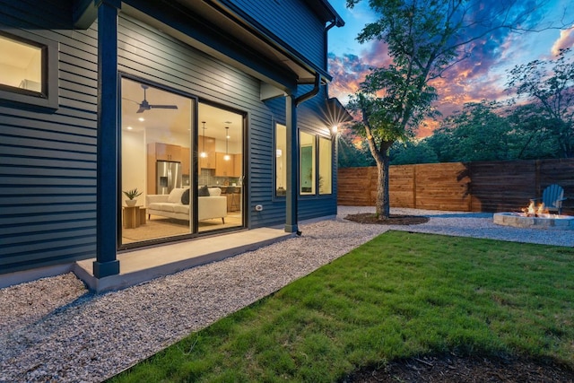6406 Cannonleague Dr Unit 2, Austin, TX 78745 - yard at dusk with a fire pit