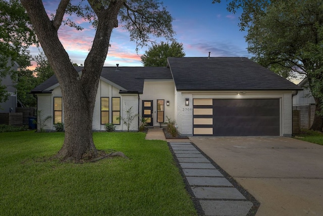 2709 Jorwoods Dr, Austin, TX 78745 - view of front of home featuring a garage, concrete driveway, a front yard, a shingled roof, and brick siding