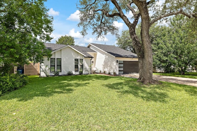 2709 Jorwoods Dr, Austin, TX 78745 - mid-century inspired home featuring an attached garage, a front lawn, concrete driveway, and roof with shingles