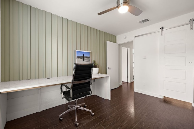 2709 Jorwoods Dr, Austin, TX 78745 - home office with a barn door, dark wood-type flooring, a ceiling fan, and built in study area