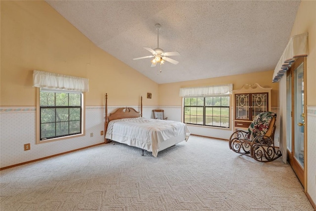 344 Fm 2984th Rd, Luling, TX 78648 - carpeted bedroom with a textured ceiling, lofted ceiling, a wainscoted wall, and ceiling fan
