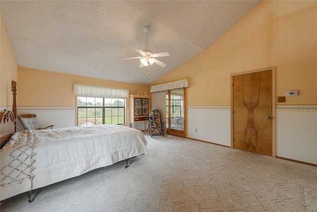 344 Fm 2984th Rd, Luling, TX 78648 - carpeted bedroom with multiple windows, a wainscoted wall, a textured ceiling, high vaulted ceiling, and wallpapered walls