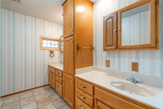 344 Fm 2984th Rd, Luling, TX 78648 - bathroom featuring wallpapered walls, vanity, tile patterned flooring, and a textured ceiling