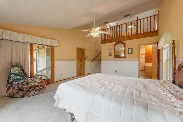 344 Fm 2984th Rd, Luling, TX 78648 - bedroom featuring wainscoting, carpet, high vaulted ceiling, and a textured ceiling
