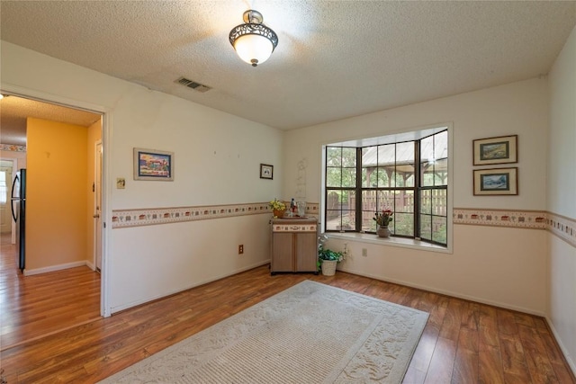 344 Fm 2984th Rd, Luling, TX 78648 - empty room with a textured ceiling and wood finished floors