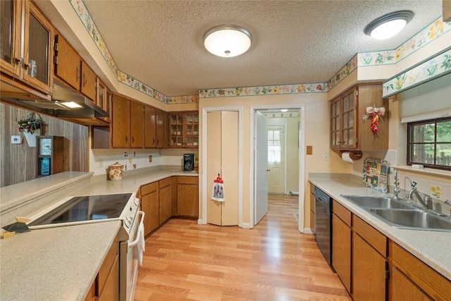 344 Fm 2984th Rd, Luling, TX 78648 - kitchen with electric stove, a textured ceiling, light wood-type flooring, light countertops, and brown cabinets