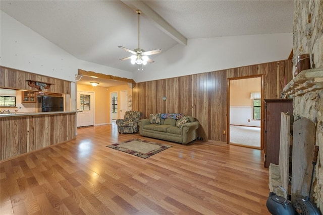 344 Fm 2984th Rd, Luling, TX 78648 - living room with wood walls, light wood-type flooring, and ceiling fan