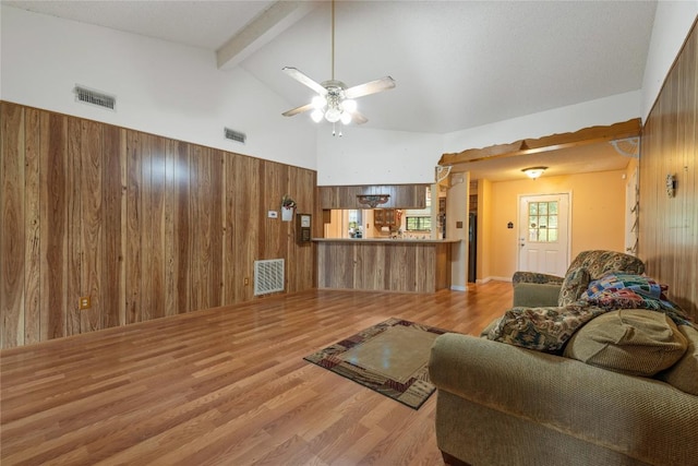 344 Fm 2984th Rd, Luling, TX 78648 - living area with wood walls, beam ceiling, wood finished floors, ceiling fan, and high vaulted ceiling