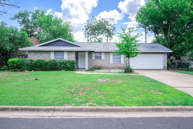 8204 Easter Cv, Austin, TX 78757 - ranch-style house featuring concrete driveway, a garage, a front yard, and stone siding