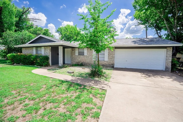 8204 Easter Cv, Austin, TX 78757 - ranch-style house with driveway, a front yard, a garage, and stone siding