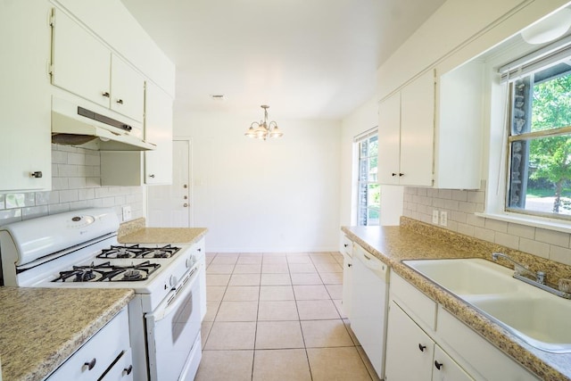 8204 Easter Cv, Austin, TX 78757 - kitchen with white appliances, under cabinet range hood, a chandelier, and decorative backsplash