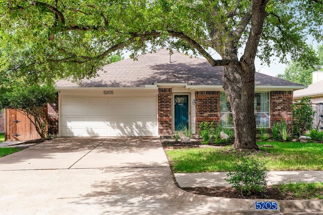 5205 Encinitas Ln, Austin, TX 78749 - ranch-style house featuring brick siding, a garage, concrete driveway, and a shingled roof