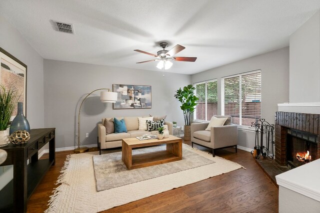 5205 Encinitas Ln, Austin, TX 78749 - living room with a fireplace, ceiling fan, and dark wood-style flooring