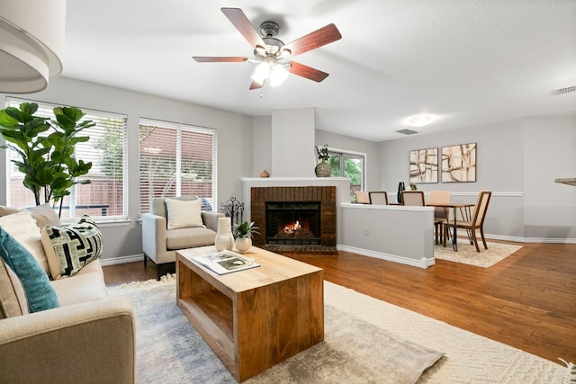 5205 Encinitas Ln, Austin, TX 78749 - living area featuring wood finished floors, a fireplace, and ceiling fan