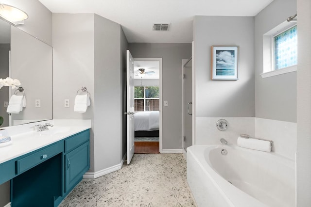 5205 Encinitas Ln, Austin, TX 78749 - ensuite bathroom featuring vanity, tile patterned floors, a bath, a stall shower, and a ceiling fan