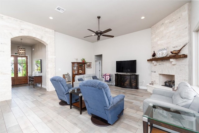 2050 Chalk Mill Xing, Salado, TX 76571 - living room featuring arched walkways, a ceiling fan, a high ceiling, recessed lighting, and a stone fireplace