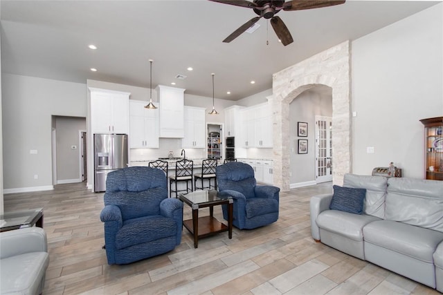2050 Chalk Mill Xing, Salado, TX 76571 - living area featuring a ceiling fan, light wood finished floors, arched walkways, and recessed lighting