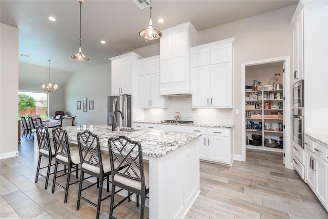 2050 Chalk Mill Xing, Salado, TX 76571 - kitchen featuring backsplash, a breakfast bar, a kitchen island with sink, white cabinets, and recessed lighting