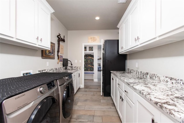 2050 Chalk Mill Xing, Salado, TX 76571 - laundry room featuring cabinet space, washing machine and clothes dryer, light wood-style flooring, and recessed lighting