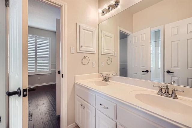 2114 Cliffs Edge Dr, Austin, TX 78733 - bathroom featuring double vanity and hardwood / wood-style flooring
