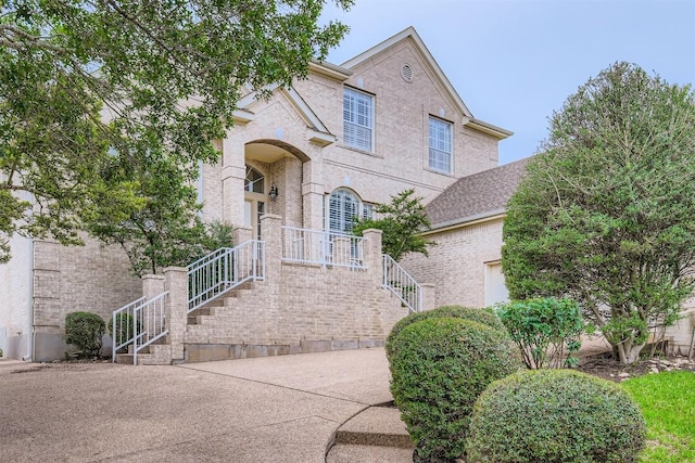 2114 Cliffs Edge Dr, Austin, TX 78733 - view of front of house featuring brick siding and concrete driveway