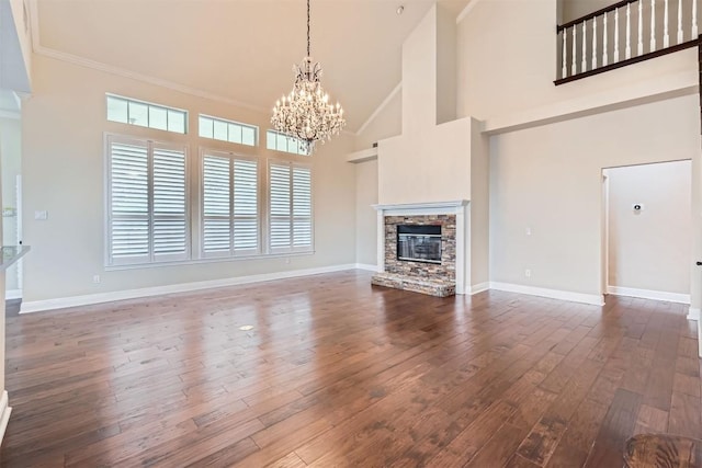 2114 Cliffs Edge Dr, Austin, TX 78733 - unfurnished living room featuring a chandelier, high vaulted ceiling, dark wood-style floors, a fireplace, and ornamental molding