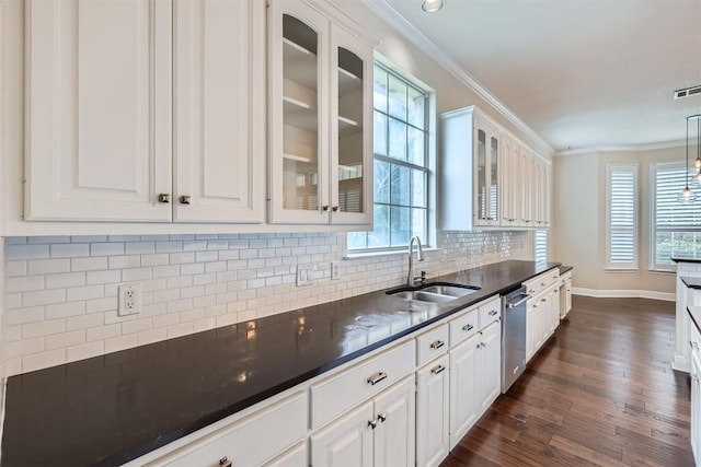 2114 Cliffs Edge Dr, Austin, TX 78733 - kitchen featuring dark countertops, ornamental molding, dishwasher, white cabinets, and backsplash