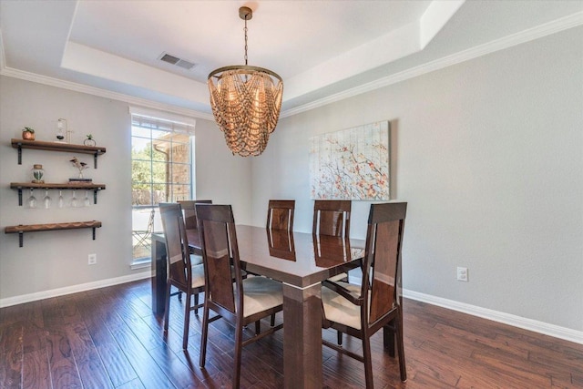 1604 Hughes Dr, Cedar Park, TX 78613 - dining room featuring a chandelier, a raised ceiling, dark wood-style flooring, and ornamental molding