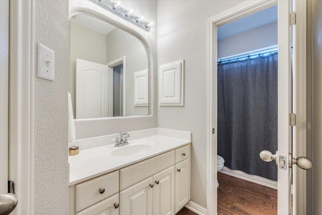 1604 Hughes Dr, Cedar Park, TX 78613 - bathroom with vanity, wood finished floors, a textured wall, and a shower with shower curtain