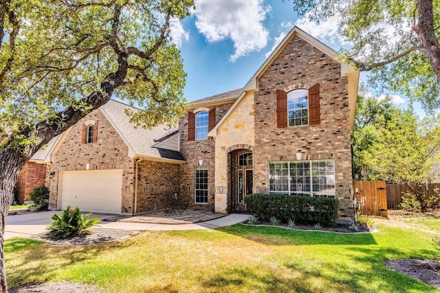 1604 Hughes Dr, Cedar Park, TX 78613 - view of front of property with brick siding, driveway, roof with shingles, stone siding, and a gate