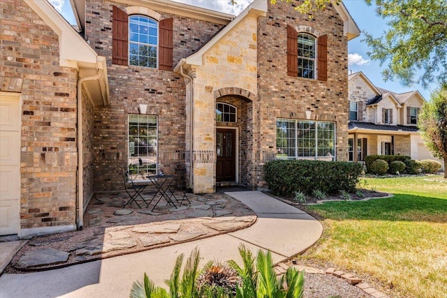 1604 Hughes Dr, Cedar Park, TX 78613 - view of front facade featuring brick siding and a front lawn