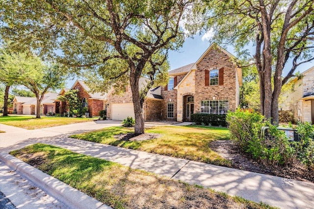 1604 Hughes Dr, Cedar Park, TX 78613 - traditional-style house with concrete driveway, brick siding, and a front yard