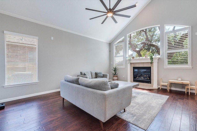 1604 Hughes Dr, Cedar Park, TX 78613 - living area featuring a ceiling fan, a tile fireplace, ornamental molding, dark wood-type flooring, and high vaulted ceiling