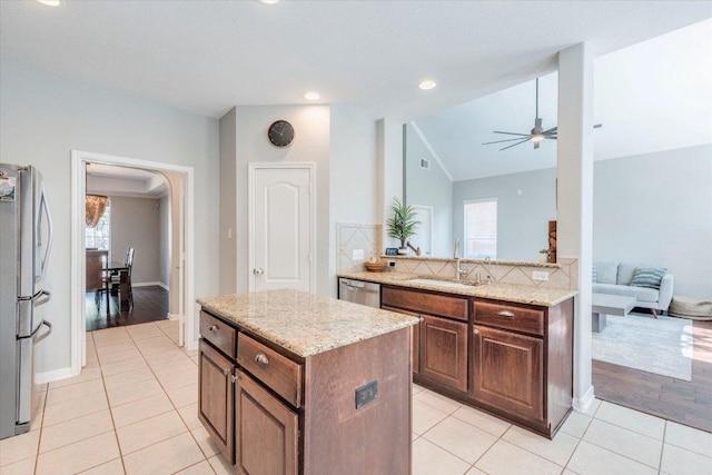 1604 Hughes Dr, Cedar Park, TX 78613 - kitchen with stainless steel appliances, vaulted ceiling, plenty of natural light, ceiling fan, and light tile patterned flooring