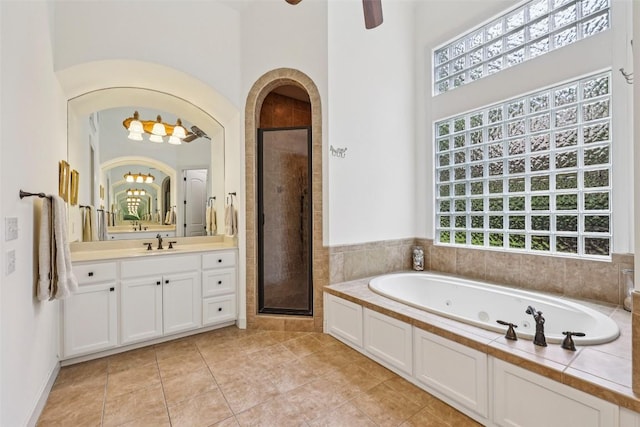 128 Squires Dr, Lakeway, TX 78734 - bathroom with a jetted tub, vanity, a shower stall, and tile patterned floors
