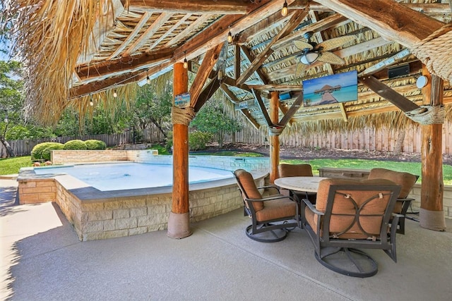 128 Squires Dr, Lakeway, TX 78734 - fenced backyard with a gazebo, outdoor dining area, a patio, and a ceiling fan