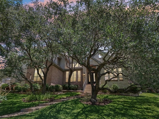 128 Squires Dr, Lakeway, TX 78734 - view of front of property with a front yard and brick siding