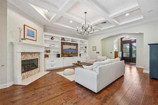 128 Squires Dr, Lakeway, TX 78734 - living room featuring arched walkways, french doors, dark wood-style flooring, coffered ceiling, and a fireplace with flush hearth