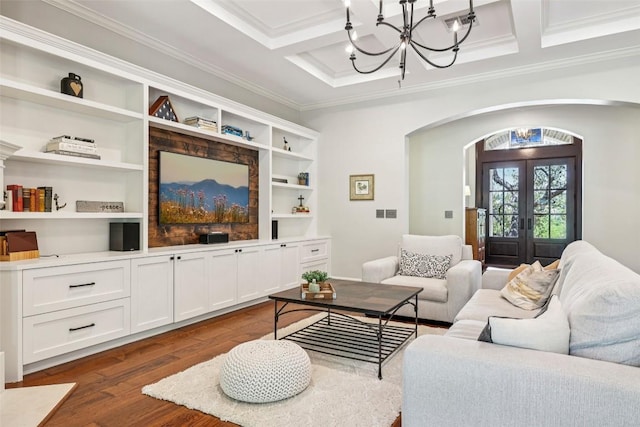 128 Squires Dr, Lakeway, TX 78734 - living area with arched walkways, a chandelier, coffered ceiling, ornamental molding, and dark wood-type flooring