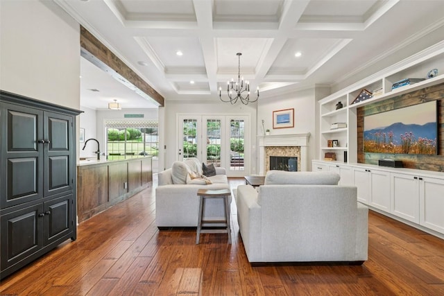 128 Squires Dr, Lakeway, TX 78734 - living area with dark wood-type flooring, a chandelier, beam ceiling, a premium fireplace, and coffered ceiling