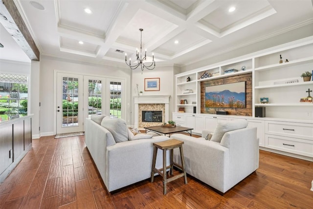 128 Squires Dr, Lakeway, TX 78734 - living room featuring a chandelier, crown molding, dark wood-style floors, beamed ceiling, and a high end fireplace