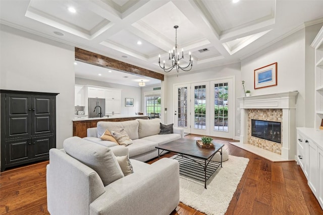128 Squires Dr, Lakeway, TX 78734 - living room with a chandelier, beamed ceiling, dark wood-style flooring, a high end fireplace, and recessed lighting