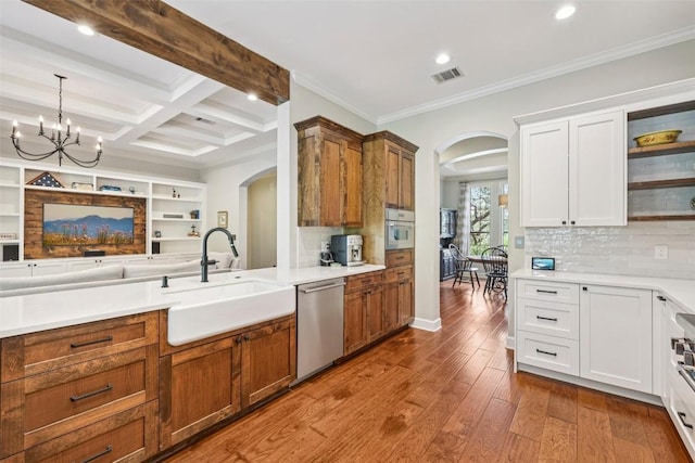 128 Squires Dr, Lakeway, TX 78734 - kitchen with arched walkways, dishwasher, open shelves, recessed lighting, and beam ceiling