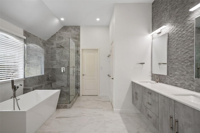 7601 Crackling Creek Dr, Austin, TX 78736 - bathroom with a freestanding bath, a shower stall, marble look tiles, double vanity, and recessed lighting